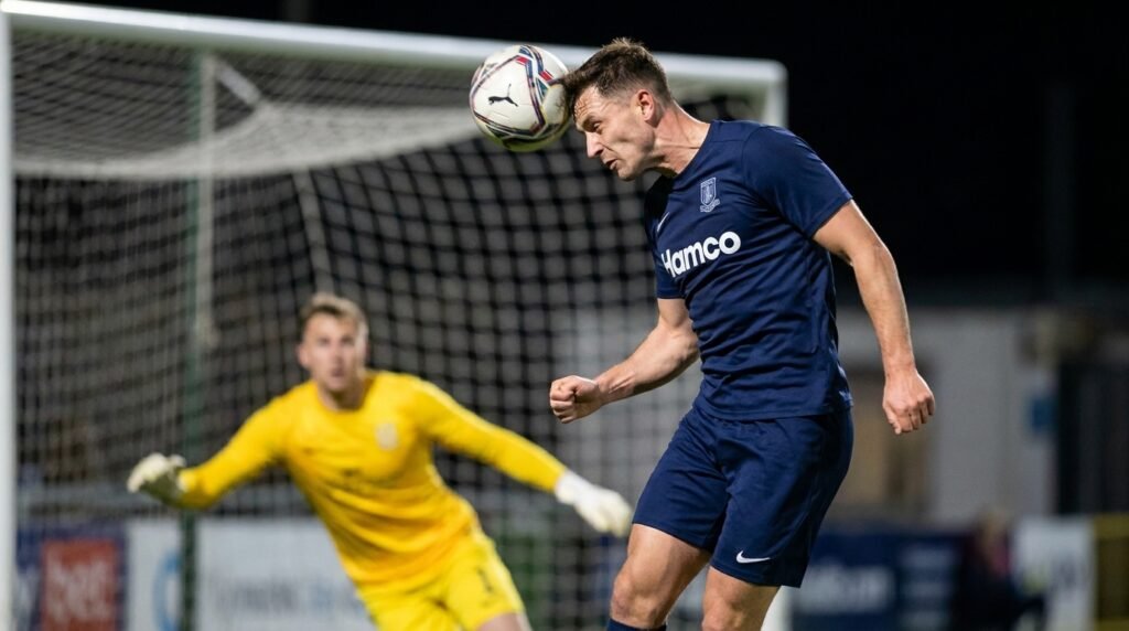 Soccer player scoring a header, one of the three goals in a perfect hat trick
