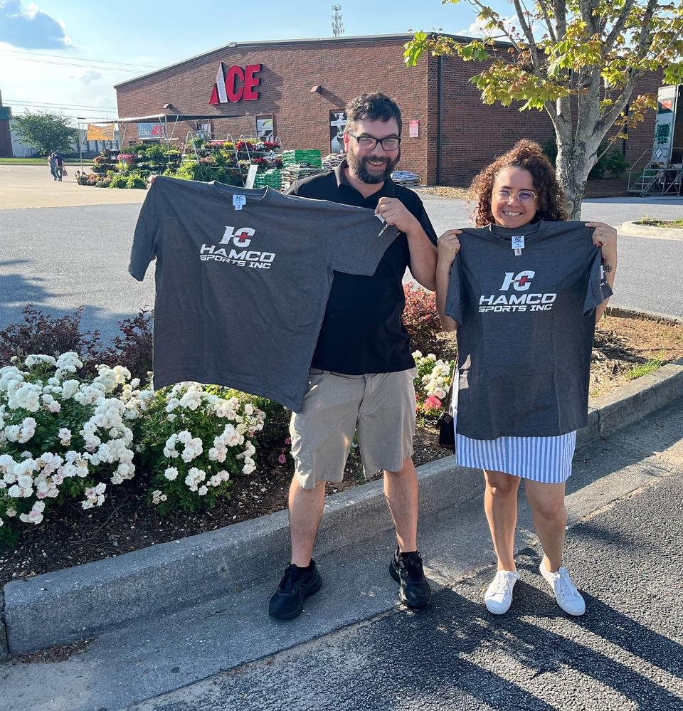 A couple holding a custom Hamco t-shirt.