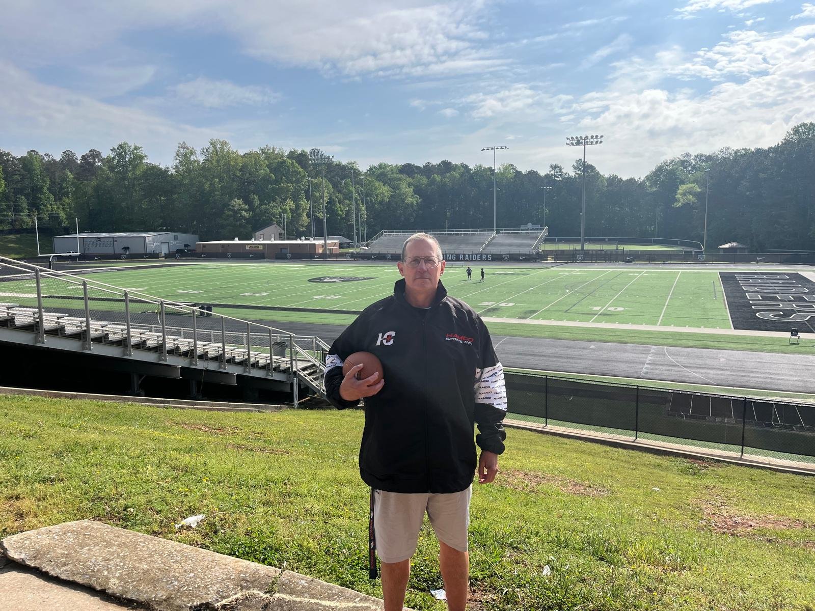 An East Paulding coach wearing a custom Hamco jacket on the field.