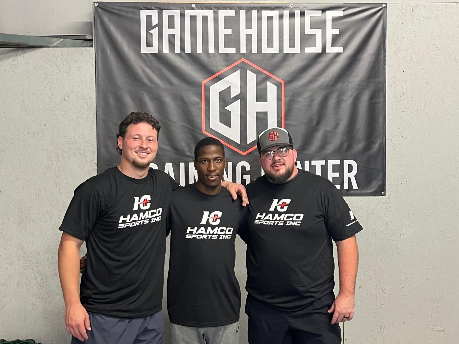 A crowd at Game House Wrestling cheering with Hamco giveaway t-shirts.