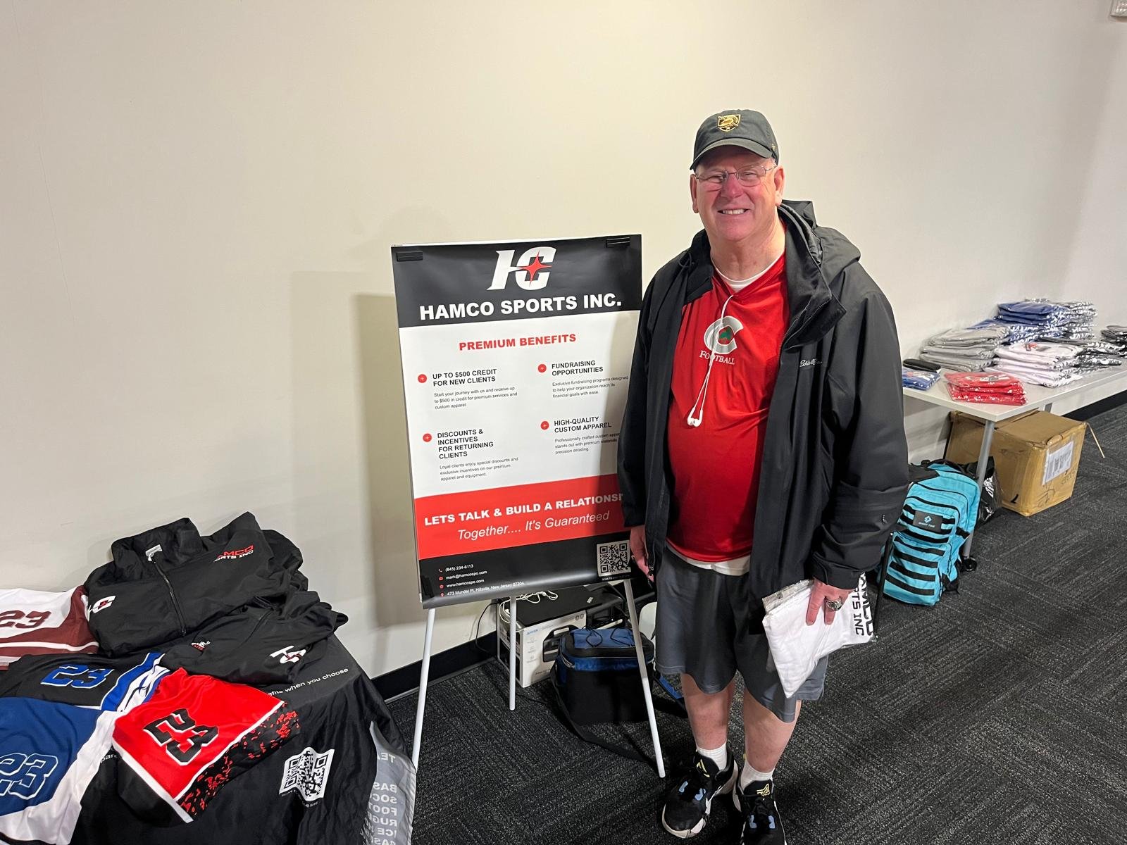 A visitor receiving a giveaway t-shirt at the Hamco booth.