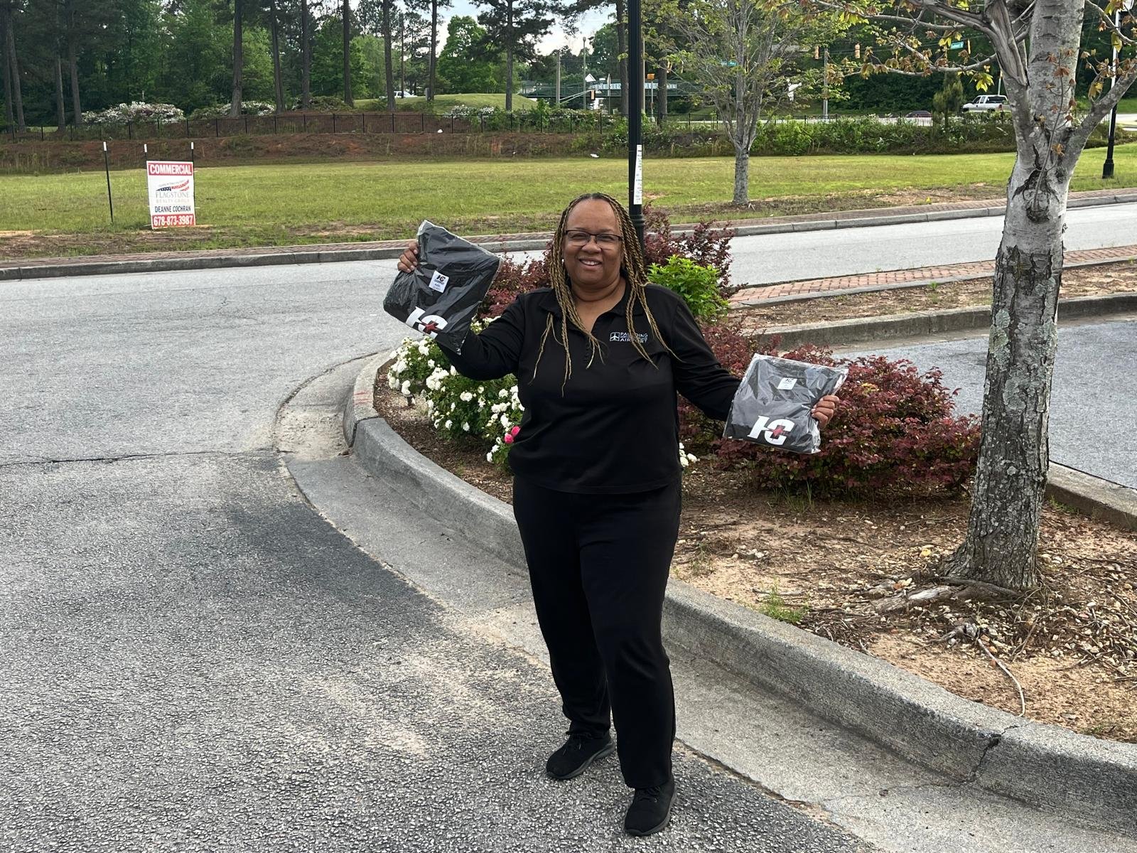 A woman in a black tracksuit with a Hamco giveaway t-shirt.