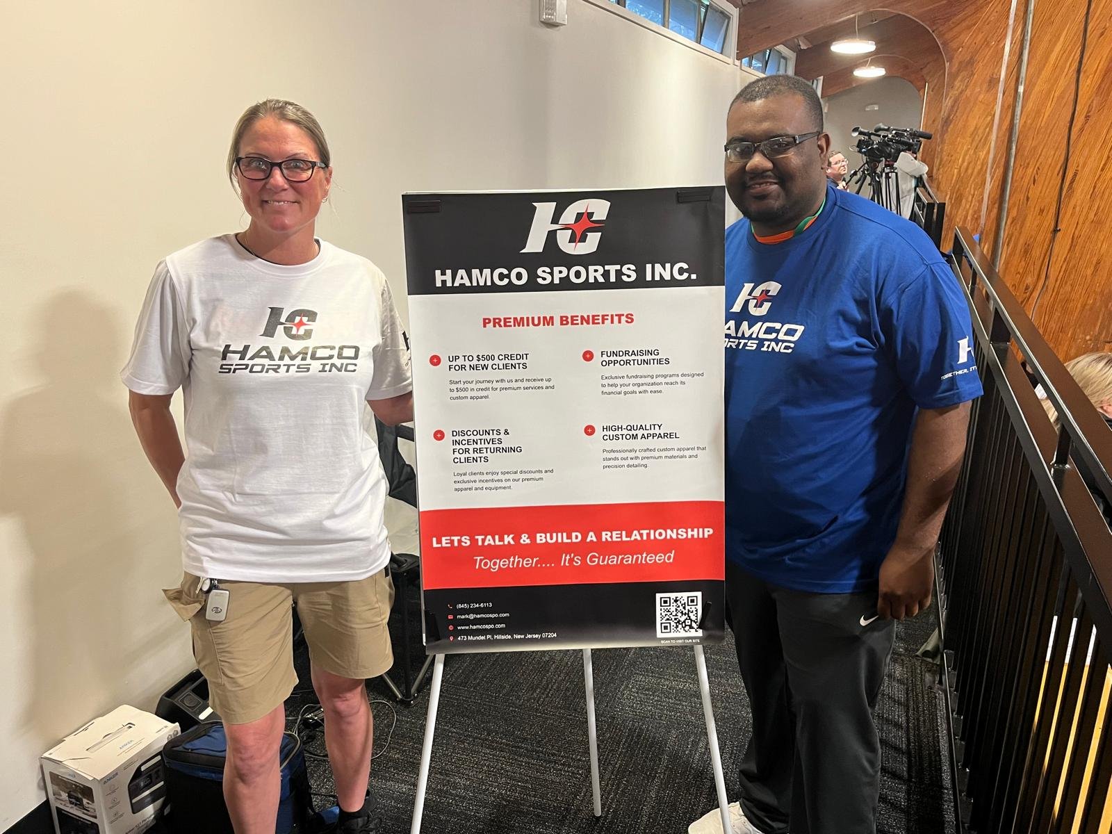 Two wrestling club members visiting the Hamco booth at the North Carolina coaches clinic.