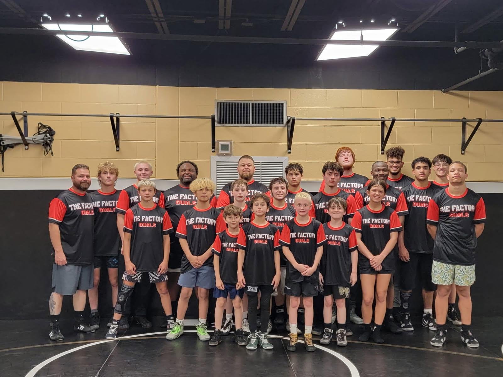 A wrestling team group photo, the squad in custom Hamco gear.